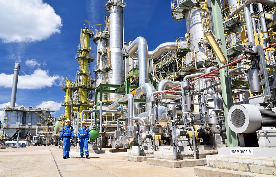 chemical industry plant – workers in work clothes in a refinery